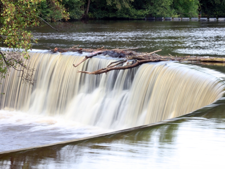 Water pouring over the horseshoe weir on the River Derwent at Belper