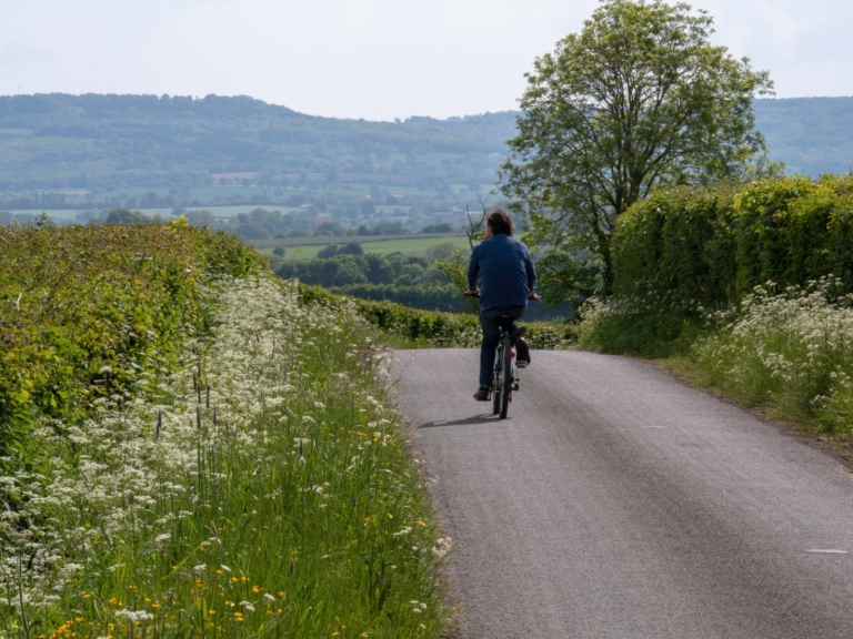 Cyclist riding along a quiet country lane